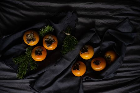 persimmon on a dark background. vegetarianism concept. Vitamins. Healthy eatingの写真素材