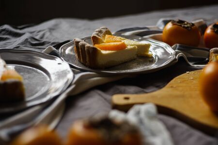 original persimmon cheesecake.side view. Beautiful dessert on a gray background. New Year. Christmas. Halloween Thanksgiving Day.の写真素材