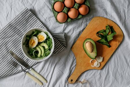 tasty and healthy breakfast. Greens with avocado and eggs. beautiful table setting. top viewの写真素材