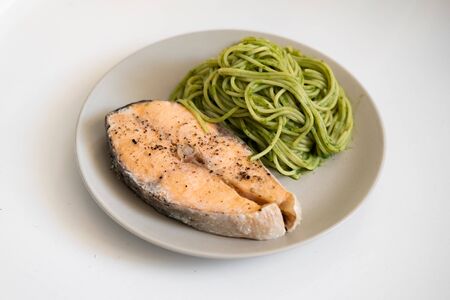 salmon steak and vegetable spaghetti. close-up. Vegetarian food. tasty and healthyの写真素材