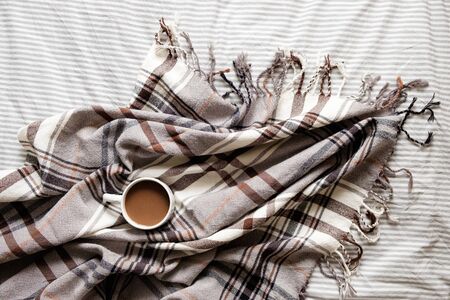 coffee and plaid. top view. fragment of the interior. coffee in bed. flat layの写真素材