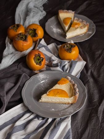 original persimmon cheesecake.side view. Beautiful dessert on a gray background. New Year. Christmas. Halloween Thanksgiving Day.の写真素材
