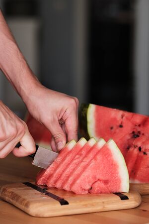 chop the watermelon with a knife. Sliced Watermelon. Without GMO. No pesticidesの写真素材