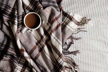 coffee and plaid. top view. fragment of the interior. coffee in bed. flat layの写真素材
