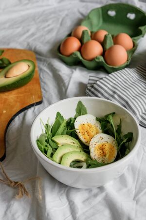 tasty and healthy breakfast. Greens with avocado and eggs. beautiful table setting. top viewの写真素材