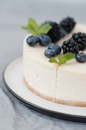 fragments of classic cheesecake with fresh berries on a gray background. close-up. Minimalismの写真素材