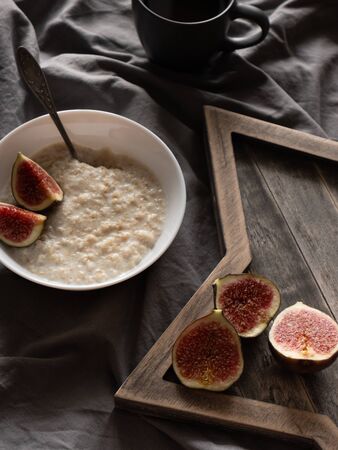 healthy oatmeal with figs on a dark background. Gluten free, lactose free, top viewの写真素材