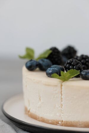 fragments of classic cheesecake with fresh berries on a gray background. close-up. Minimalism