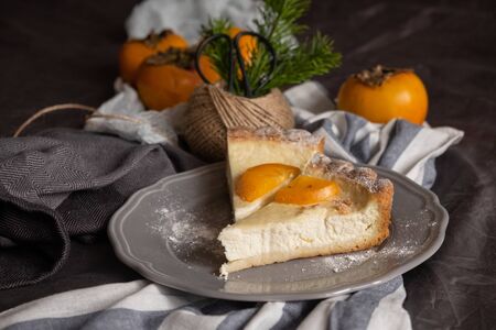 original persimmon cheesecake.side view. Beautiful dessert on a gray background. New Year. Christmas. Halloween Thanksgiving Day.の写真素材