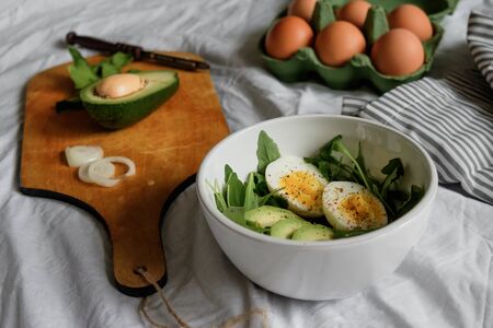 flat lay breakfast. Wholesome food, beautiful serving. Eggs, avocados and greens. top view