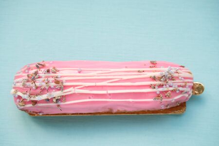Tasty eclair, a cup of black coffee and a cactus on a blue background. Food in the style of minimalism. Breakfast concept. Modern breakfast. People lifestyle concept. Mock up copy space.の写真素材