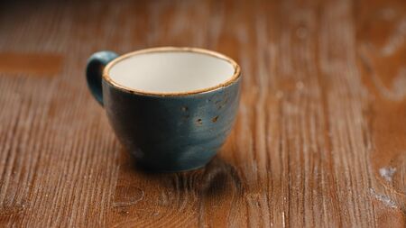 Little cup with espresso on a dark wooden table in a cafe. Tasty coffeeの写真素材