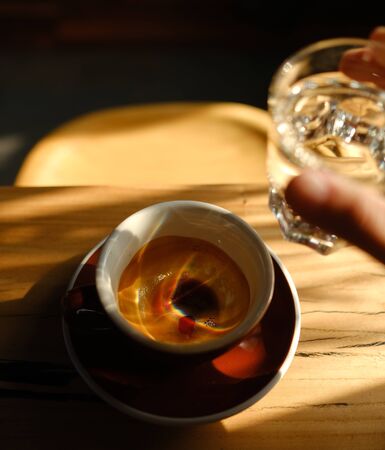 Stylish served specialty alternative black coffee. Filter pour-over coffee served in crystal glass and decanter. Aesthetics coffee. Manual brewing still life. Morning coffee in the cafeの写真素材