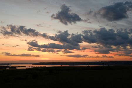 Beautiful sunset in nature. Blue sunset overlooking the river. The concept of tourism and solitude with natureの写真素材