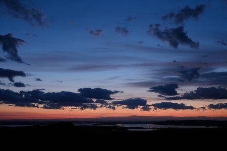 Beautiful sunset in nature. Blue sunset overlooking the river. The concept of tourism and solitude...