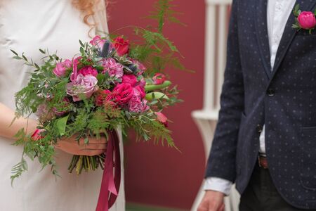Bride and groom at a wedding ceremony.Bride holds a wedding bouquet, wedding dress, wedding details. Beautiful luxury wedding blog concept. Summer wedding.の写真素材
