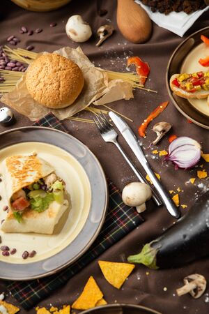 pepper corn black bean quinoa burritos.  flat lay, shot from above on a black background. Mexican food mix colorful background Mexicoの写真素材