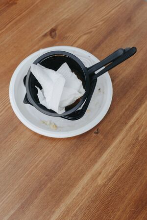 Plastic dishes after use. Food in plastic dishes in a cafe is a new reality during the coronavirus...