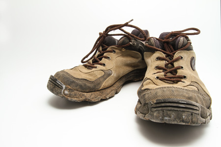 a pair of dirty old brown shoes that been used and abusedの写真素材
