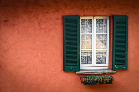 red wall, green blinds and white windowの写真素材