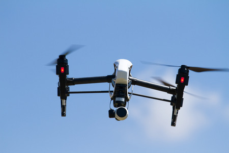 Quadrocopter UAV with 4K camera flying high in the skyの写真素材