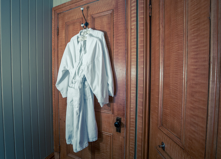 hanging white bathrobe