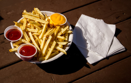 french fries with ketchup and cheeseの写真素材