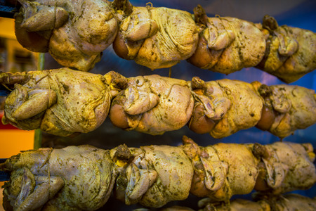 Grilling whole chickenの写真素材