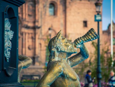 male horn blower fountain in Cusco Peruの写真素材