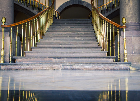 staircase with gold railing