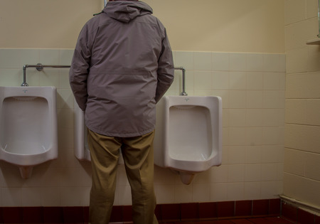 man using the urinalの写真素材