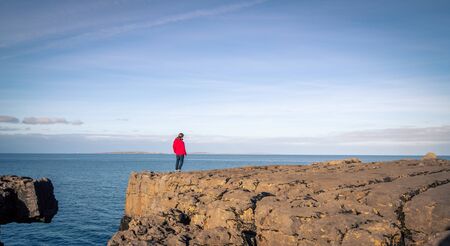 woman on the rocky shores of Island