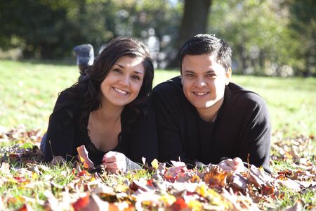 beautiful couple relax in autumn parkの写真素材