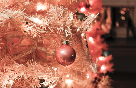 a unique pink christmas tree with pink glass bulb ornaments is festive with copy spaceの写真素材