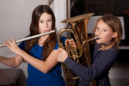 two girls rehearse or practice their band instrumentsの写真素材