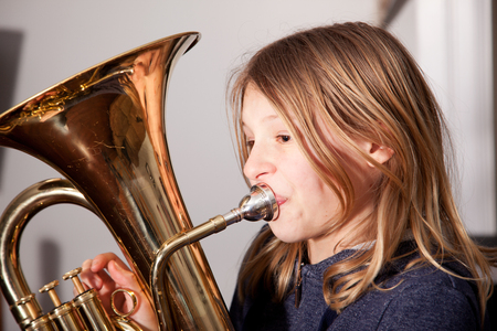 Profile of young girl playing baritone instrumentの写真素材