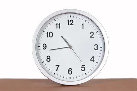 studio shot with copy space of a silver analog clock