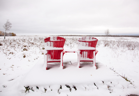 celebrating Canada's 150th with the famous Adirondack two red chairs at Elk Island Park in Alberta on a snowy dayの写真素材