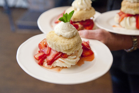 beautiful biscuits strawberries and cream on a dessert plate