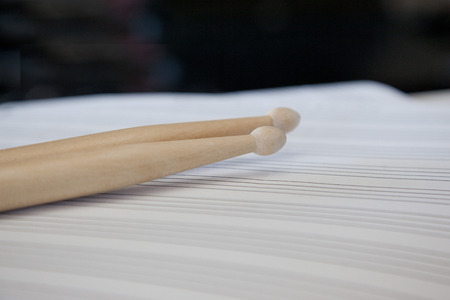Blank sheet music with two wooden drum sticksの写真素材