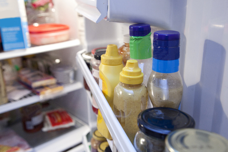 Bottles and containers inside a fridgeの写真素材
