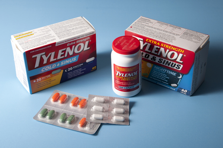 Halifax, Canada- May 31, 2019: Assorted Tylenol and Dayquil Nyquil cold medication against a blue backdropのeditorial素材