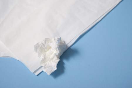 Close up of white tissues for nose blowing against blue backgroundの写真素材