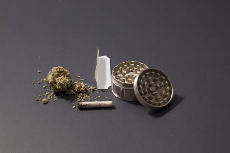 partially smoked doobie with marijiana, grinder, and a few grams of weedの写真素材