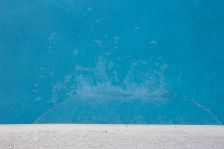 looking down at the water feature fall of a swimming poolの写真素材