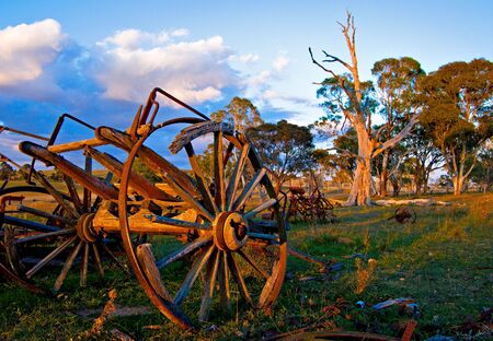 a nice bright image of an old cart left to rot on the farm の写真素材
