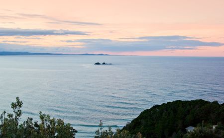 image looking out from the coast out to a little island in the seaの写真素材
