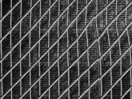 dark image of a stack of solid strong storage boxes metal barrier with steel cables in frontの写真素材