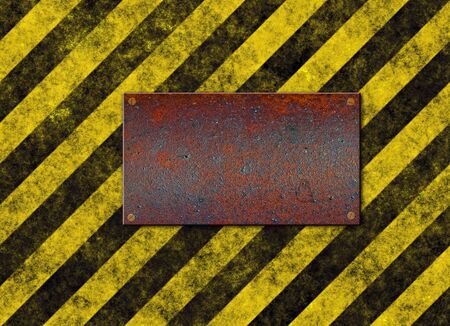 old grungy yellow hazard stripes with rusted metal plaqueの写真素材