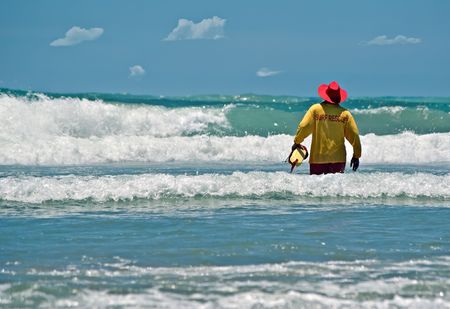 a live saver ventures out into the surf